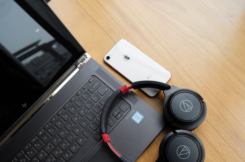 headphones lying on top of a computer