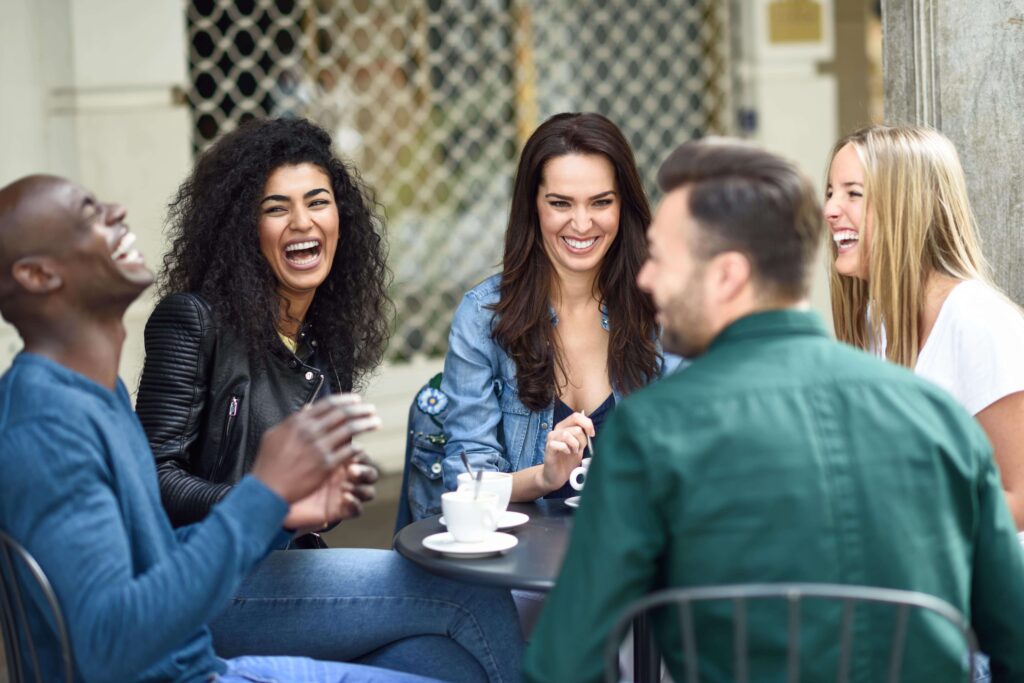 Group of friends at a bar in Portugal communicating using Portuguese phrases