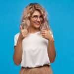 cheerful-hipster-girl-trendy-round-eyewear-making-thumb-up-gesture-with-both-hands-smiling-joyfully-showing-her-support-respect-someone-saying-good-job-well-done-min-150x150.jpg