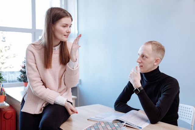 Dutch pronunciation student practising sounds with a tutor during an in-person language lesson.